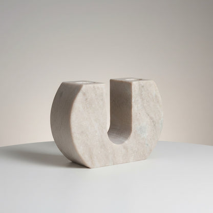 Morchana marble dual arch candle holder — front view showing wide U-shaped form with two taper wells in pale beige stone