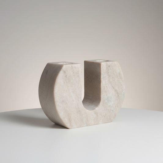 Morchana marble dual arch candle holder — front view showing wide U-shaped form with two taper wells in pale beige stone