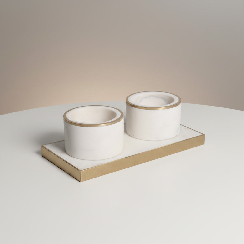 Indian white marble dual pinch pot set with brass inlay rim — two cylindrical cups on rectangular brass-framed marble tray, angled hero shot