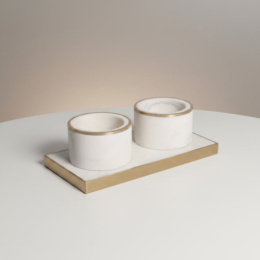 Indian white marble dual pinch pot set with brass inlay rim — two cylindrical cups on rectangular brass-framed marble tray, angled hero shot