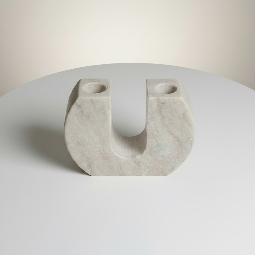 Morchana marble arch candle holder — angled view showing open arch cutout and pale stone surface with fine veining