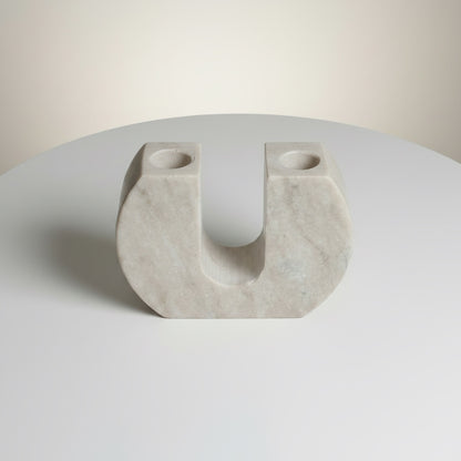 Morchana marble arch candle holder — angled view showing open arch cutout and pale stone surface with fine veining