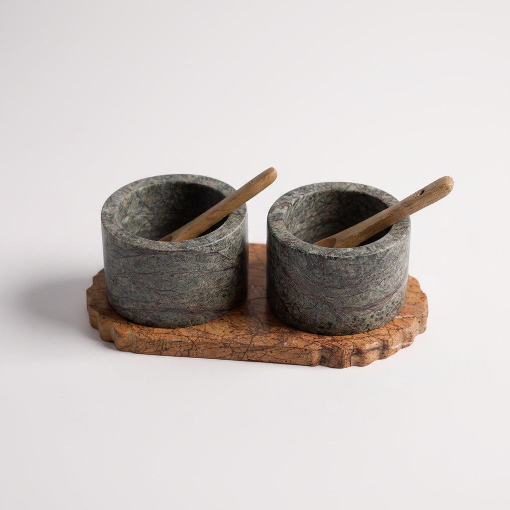 Selvada marble pinch pot cups with wooden spoons on live-edge tray — side-angled product shot showing raw stone texture