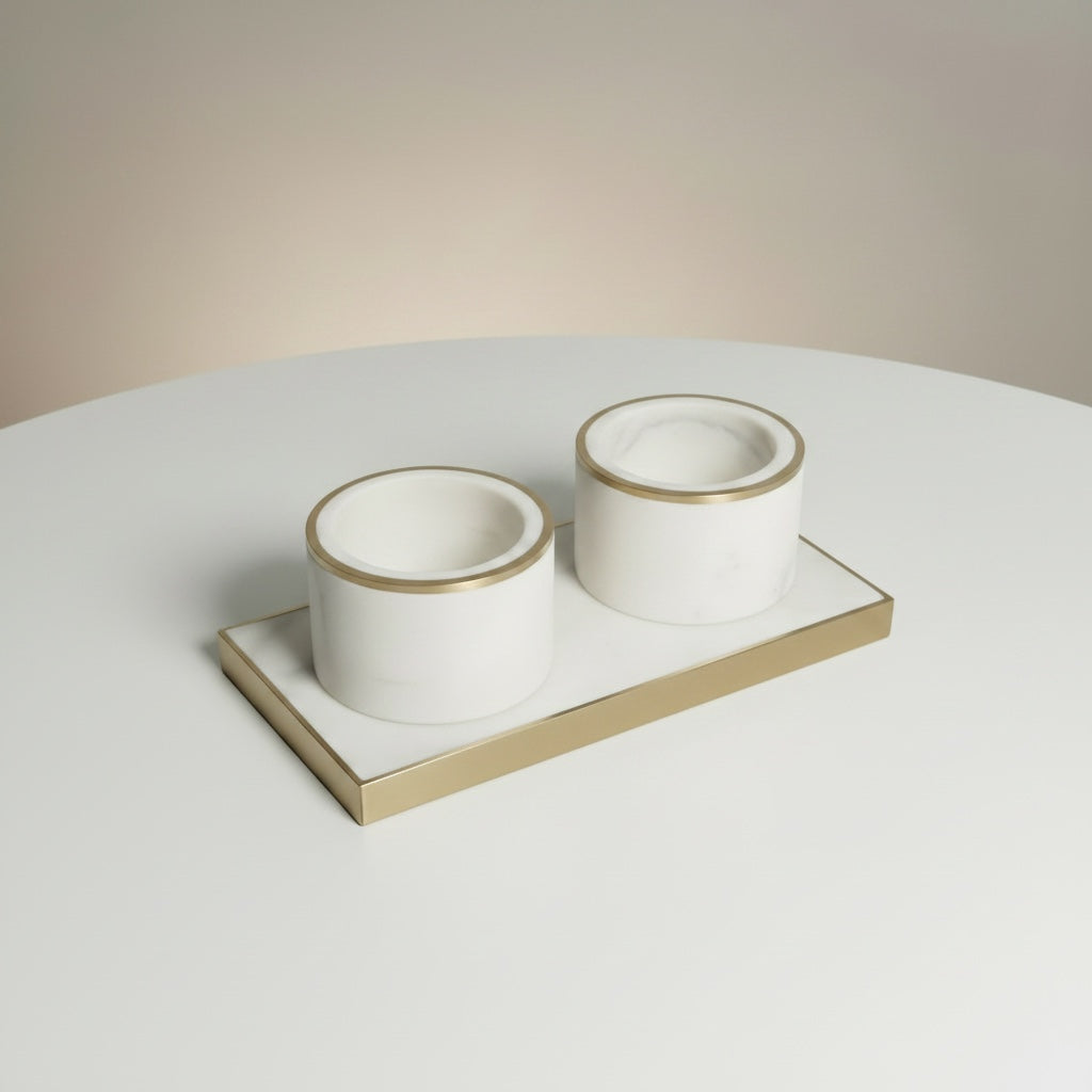 Indian white marble pinch pot cups with brass ring inlay — clean angled view on white surface showing empty cups from above